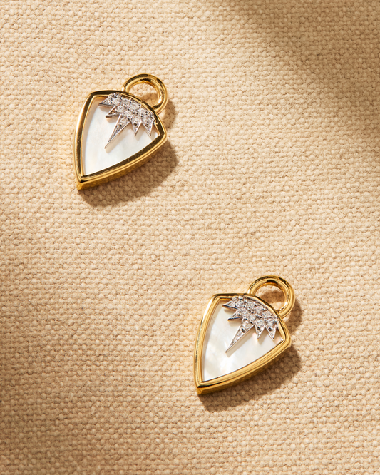 Juma shield earring charms in gold with mother of pearl and crystal sunburst design, designed to attach to hoop earrings