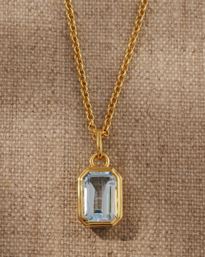 Lumi 18ct gold plated emerald cut blue topaz pendant on a layered gold chain necklace