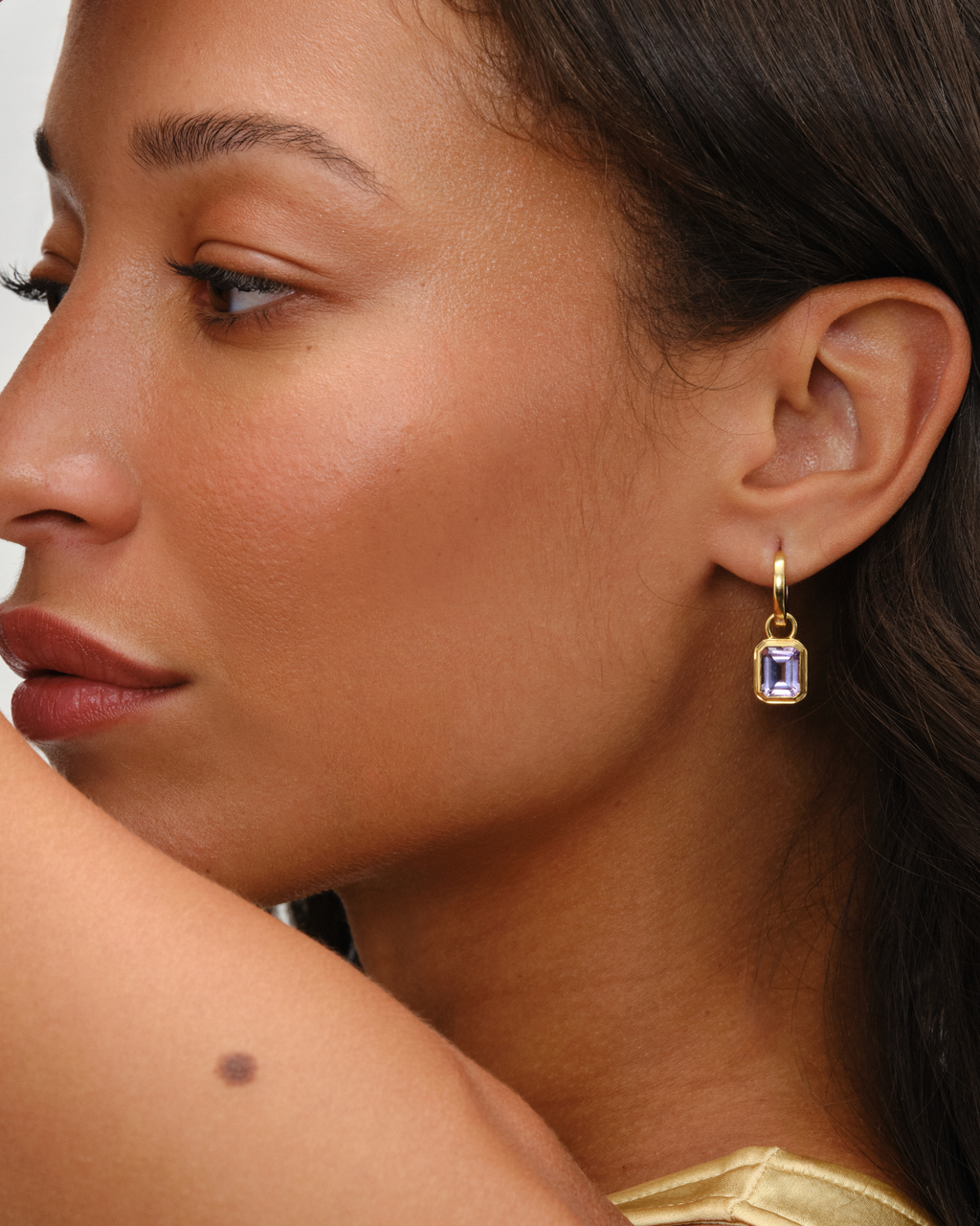 Cara reversible huggie hoop earrings in 18ct gold plated sterling silver, gold one side silver the other. Paired with Lumi emerald cut pink amethyst earring charm in 18ct gold plated bezel setting