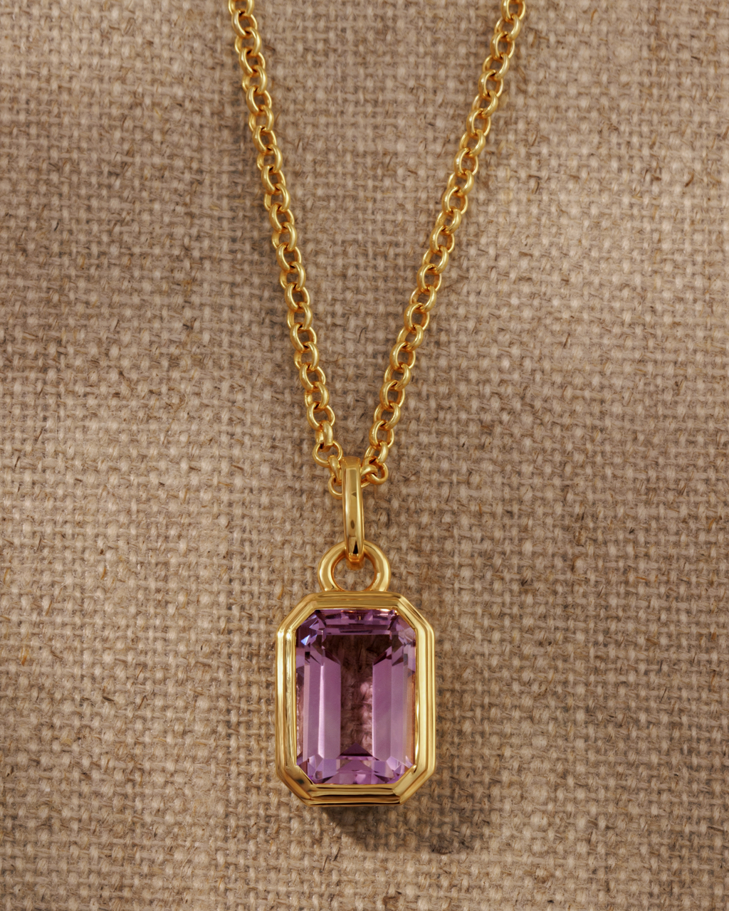 Lumi 18ct gold plated emerald cut pink amethyst pendant styled on a layered gold  chain necklace
