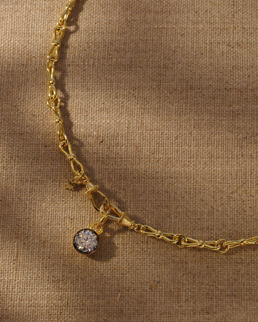 ODETTE round moissanite pendant on the EADIE bow tie chain