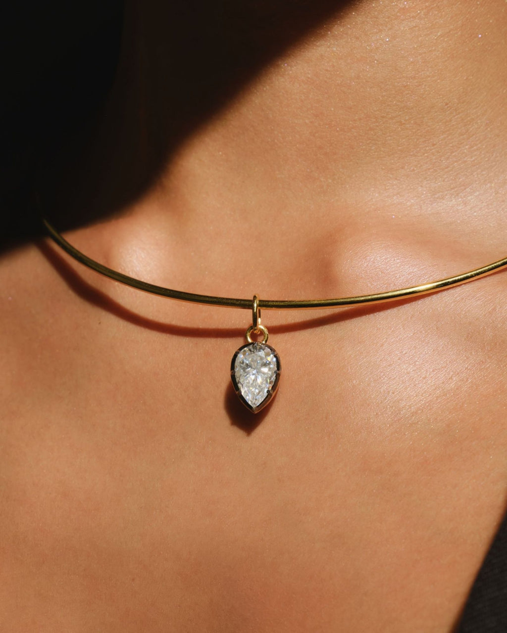 PIA pear moissanite pendant on the COLETTE gold torque