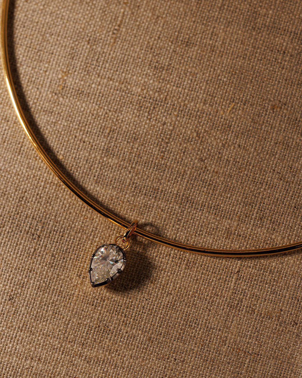 PIA pear moissanite pendant on the gold COLETTE torque, close up