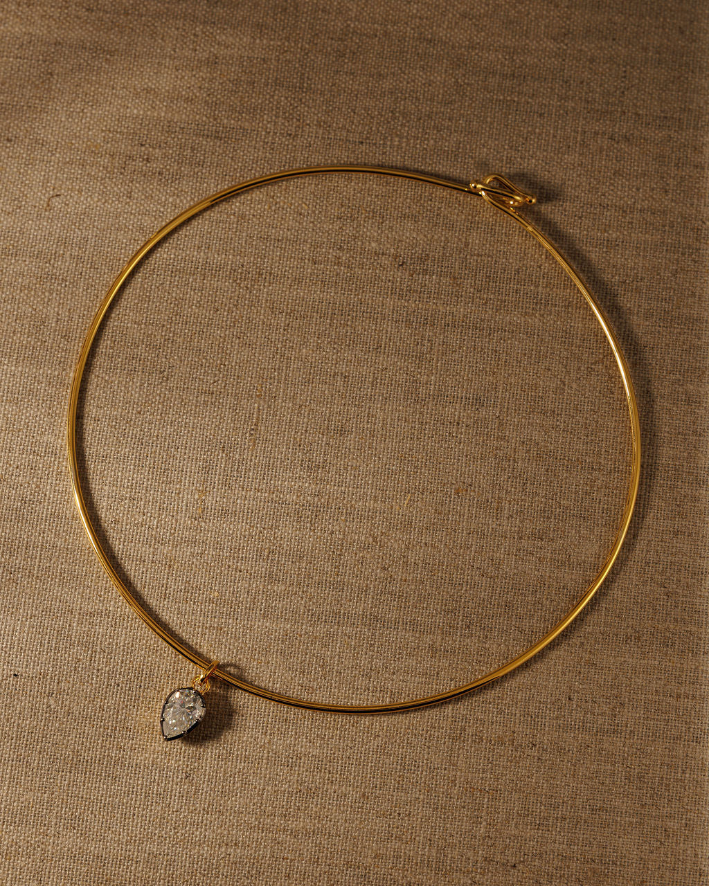 PIA pear moissanite pendant on the gold COLETTE torque
