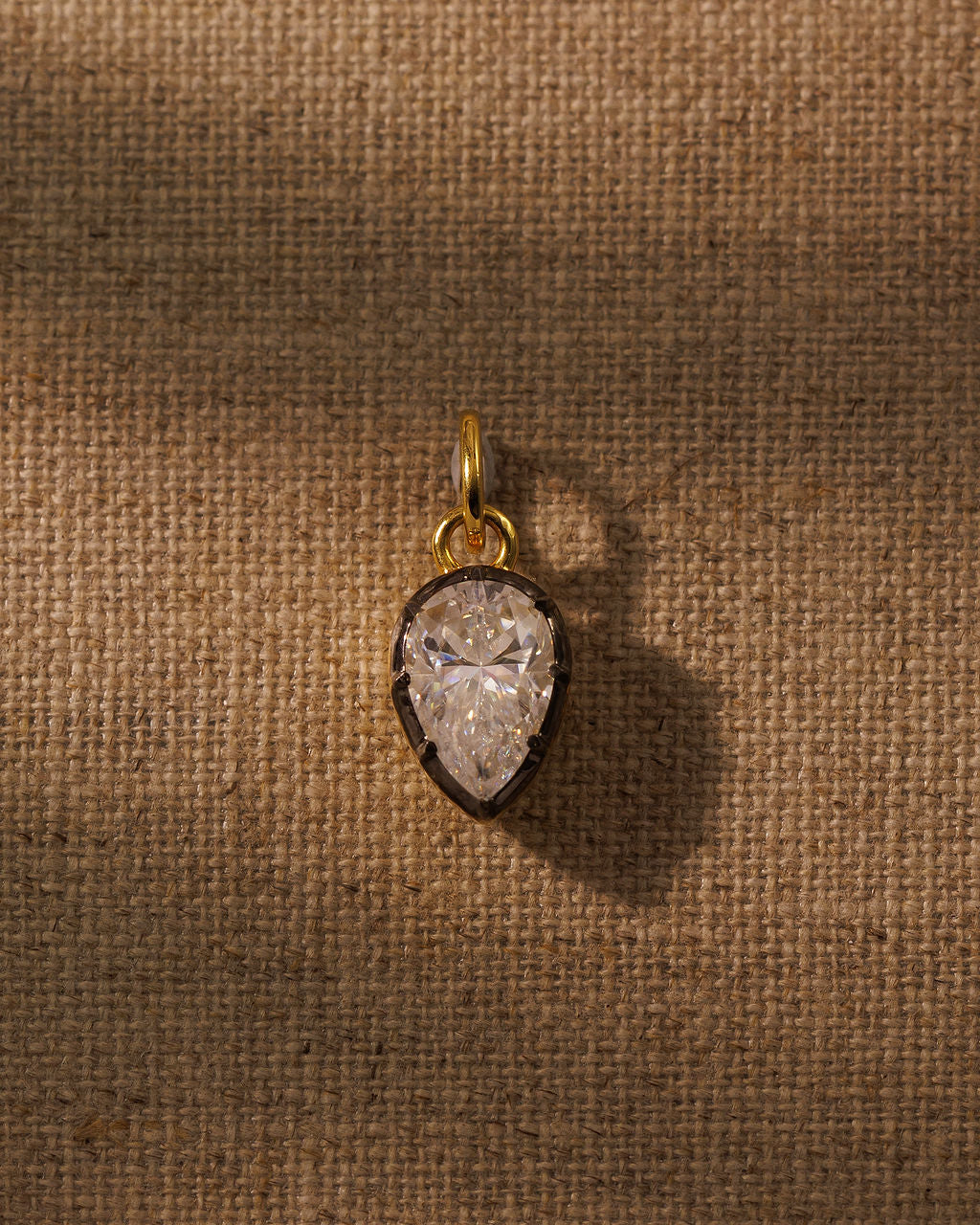 PIA pear moissanite pendant on the COLETTE gold torque