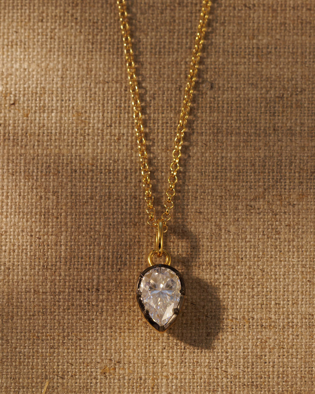 PIA pear moissanite pendant on the gold IVY chain