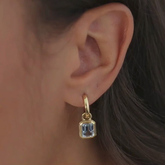 Cara reversible 18ct gold and silver hoop earrings with Lumi emerald cut blue topaz drop charm