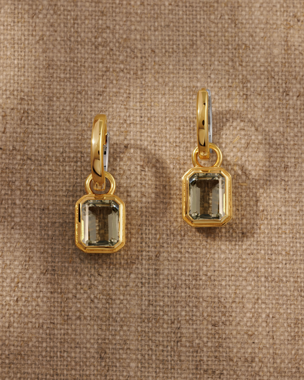 Cara reversible huggie hoop earrings styled with Lumi emerald cut green amethyst charm in 18ct gold