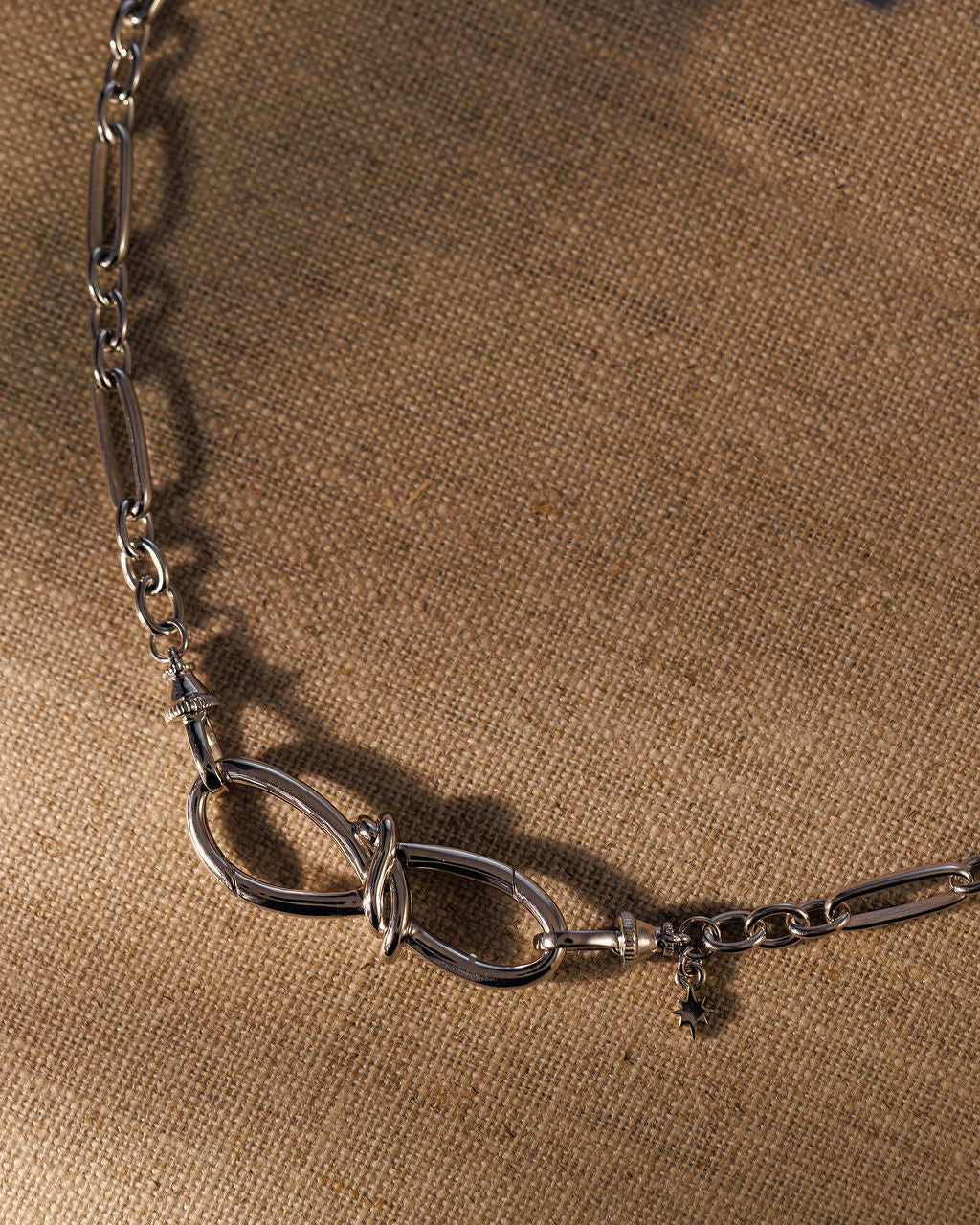 TRIXIE bow extender in sterling silver worn on a silver chain